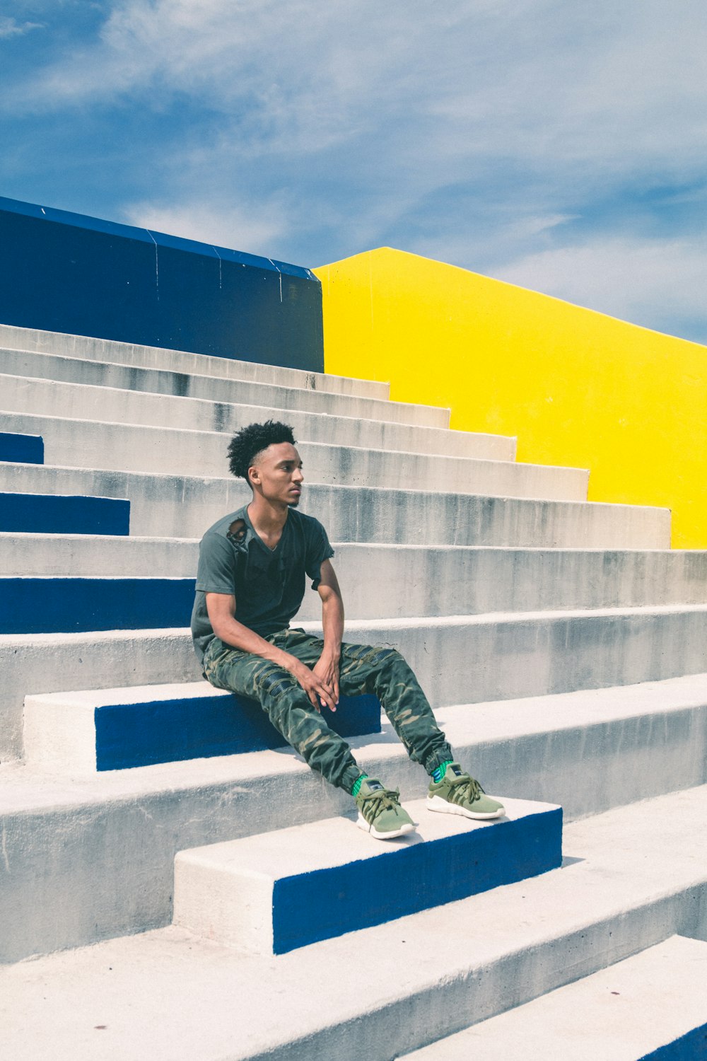 man sitting on concrete stairs