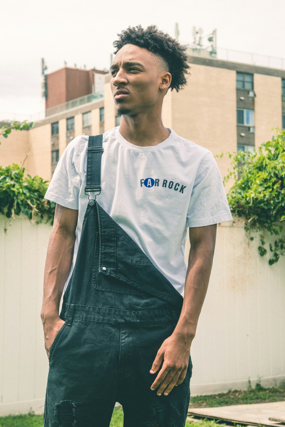 man standing near beige building