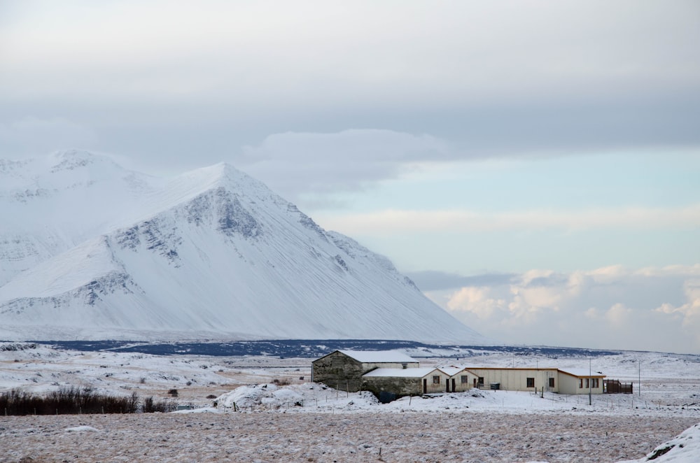 white house near snow mountain