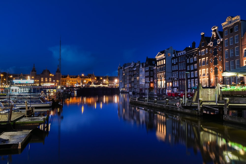 buildings beside body of water during nighttime