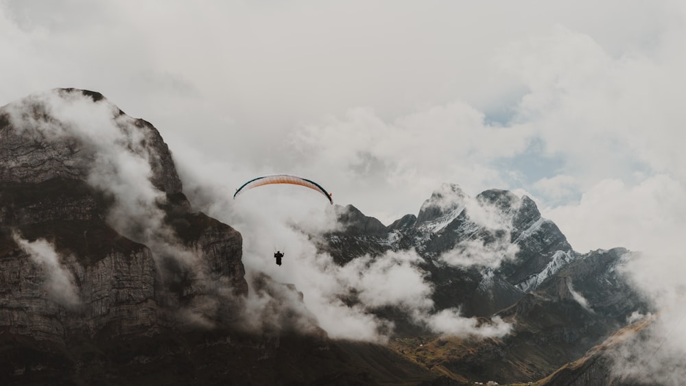 person on parachute near the mountain