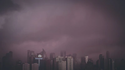 A dark cityscape with towering futuristic buildings under a stormy sky.