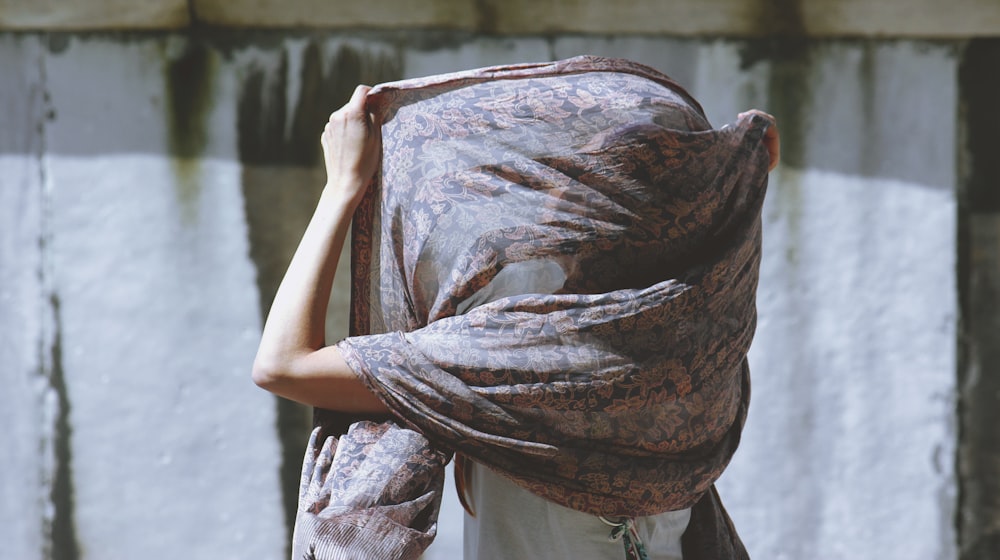 woman using brown floral scarf