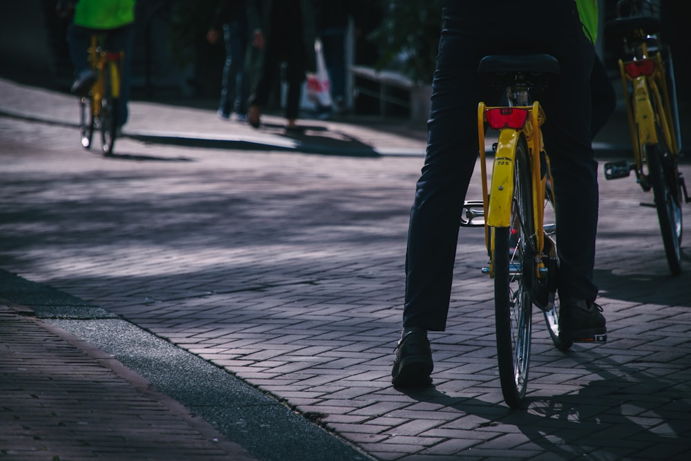 person riding on yellow bicycle during daytime