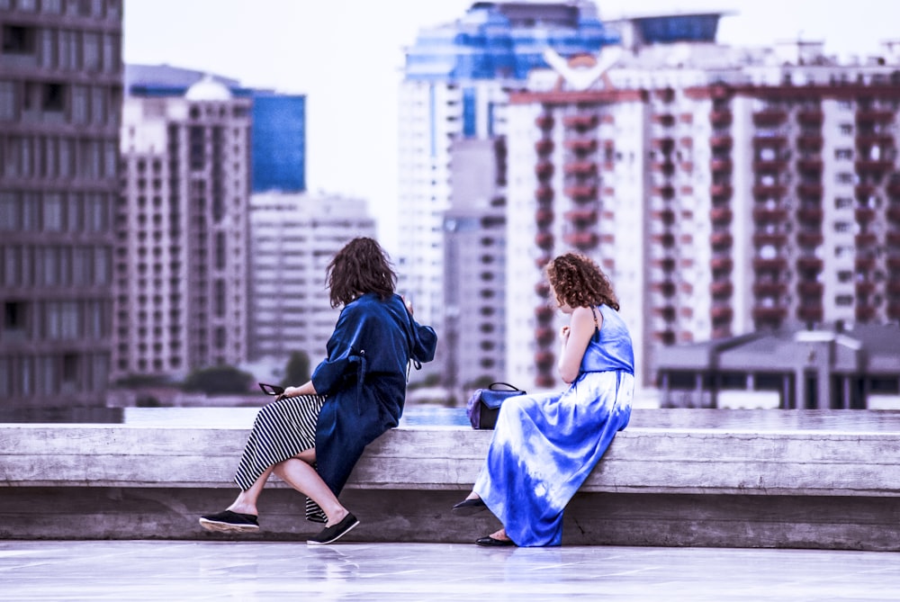 two women sitting on the roof