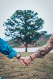 two persons holding hands