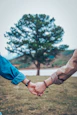 two persons holding hands