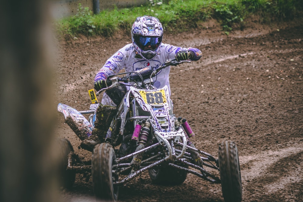 person pushing gray ATV