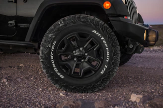 Set of all-terrain tires gripping rocky terrain.