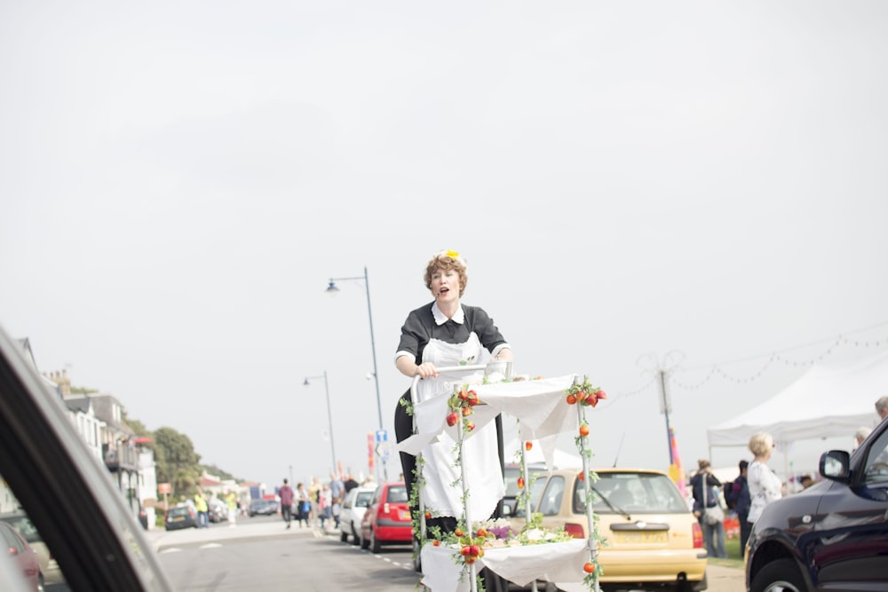 woman riding white and green cart