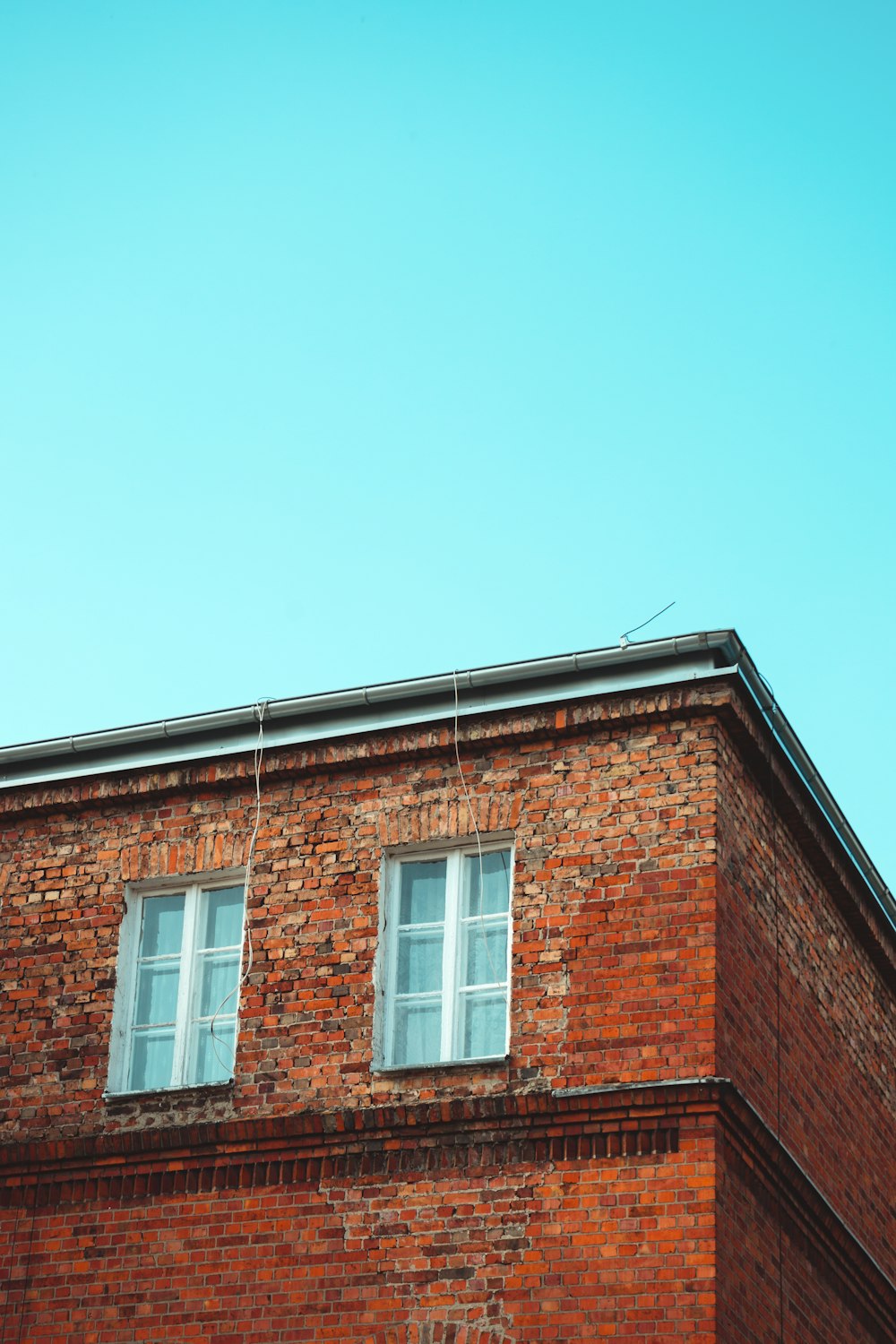 red brick house at daytime