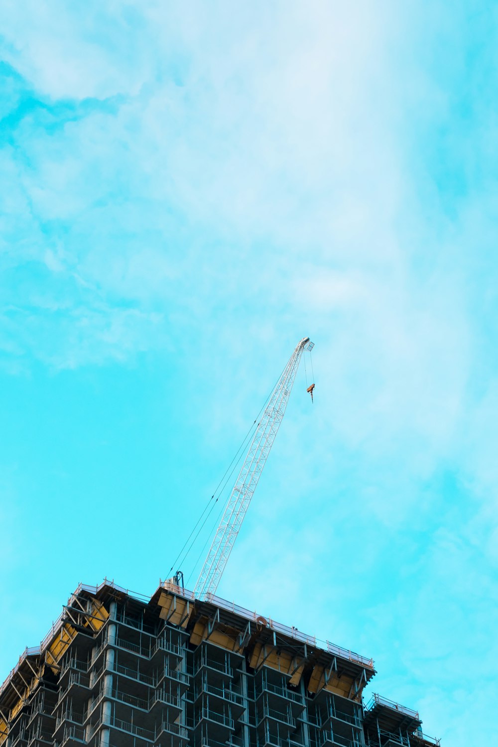 gray metal crane under cloudy sky