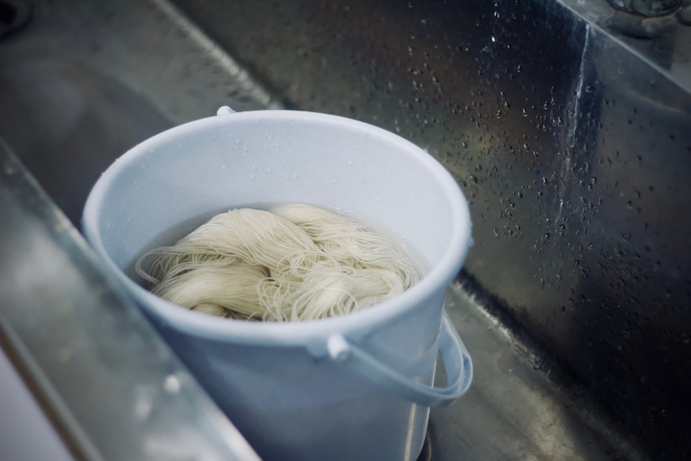 Seau rond en plastique blanc avec nouilles