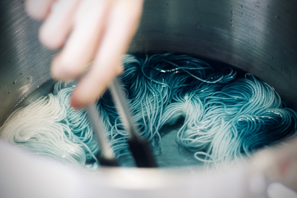 person cooking pasta