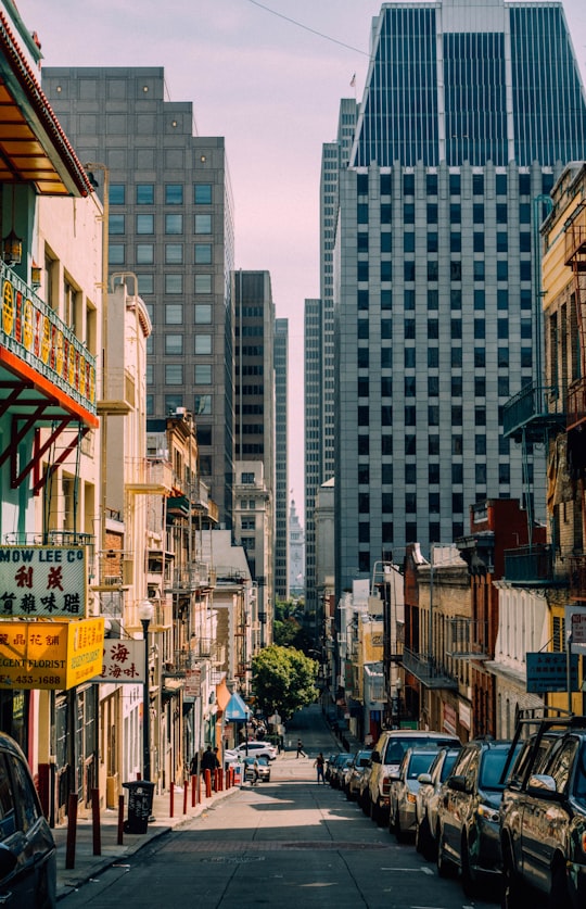 assorted-color vehicle park on the street during daytime in Chinatown San Francisco United States