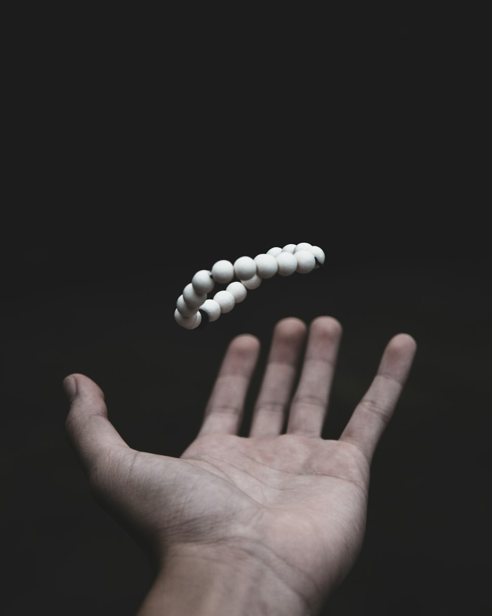 shallow focus photo of beaded white bracelet