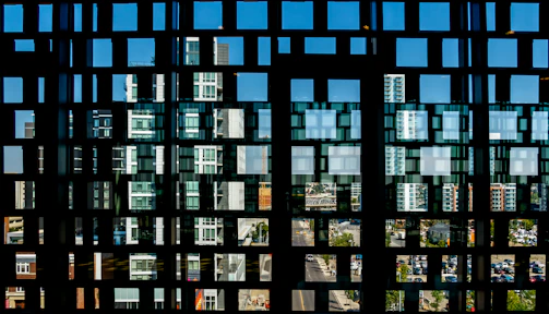 A futuristic digital grid overlaying a cityscape at night, symbolizing connected technology.