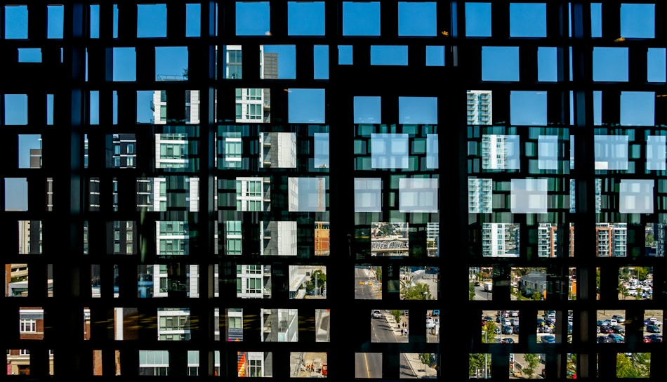 A sleek, layered grid of geospatial data points overlaid on a city map in monochrome tones.