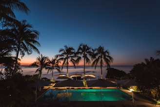 pool surrounded with trees and gazebos