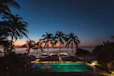 pool surrounded with trees and gazebos