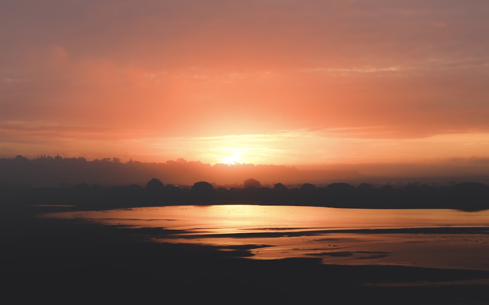 sunset over the horizon with clouds