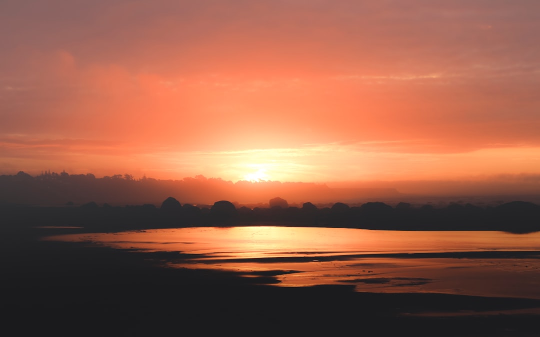 sunset over the horizon with clouds