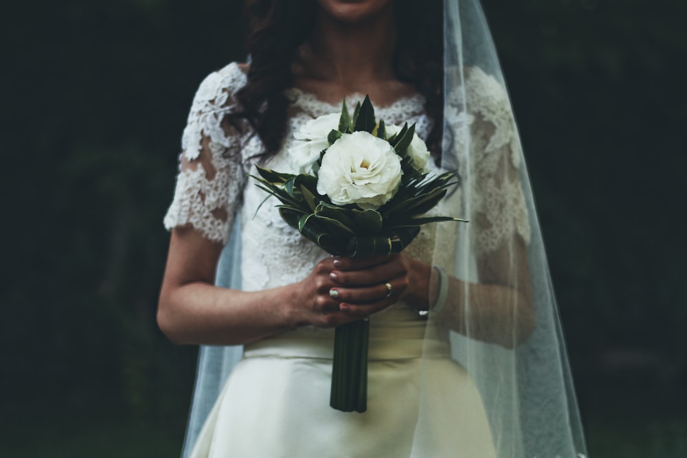 woman holding white rose