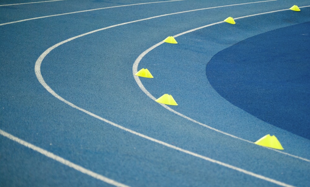 blue curved track field at daytime