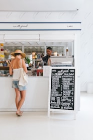 woman with white spaghetti strap top near the bar