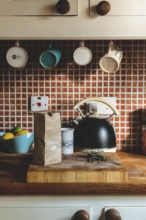 A cozy kitchen scene featuring colorful mugs and fresh produce.