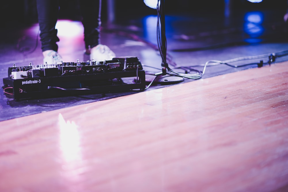 black audio mixer on brown surface