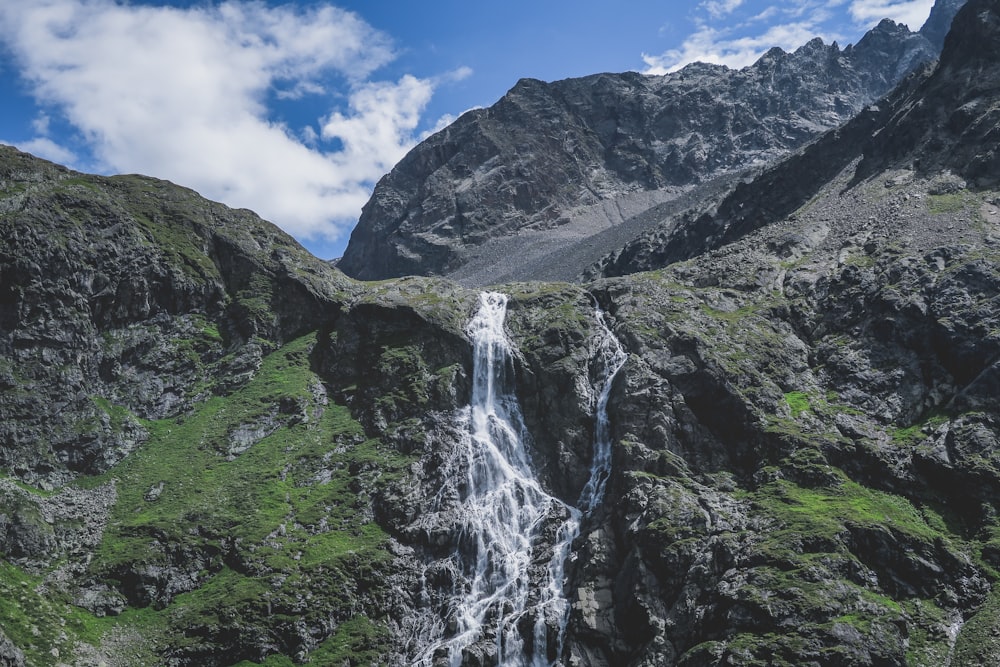 waterfalls near mountains during daytime