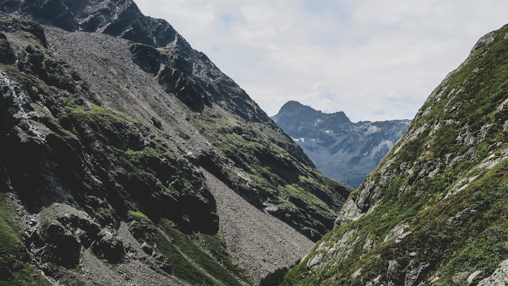 green and gray mountains under white cloudy sky during daytime