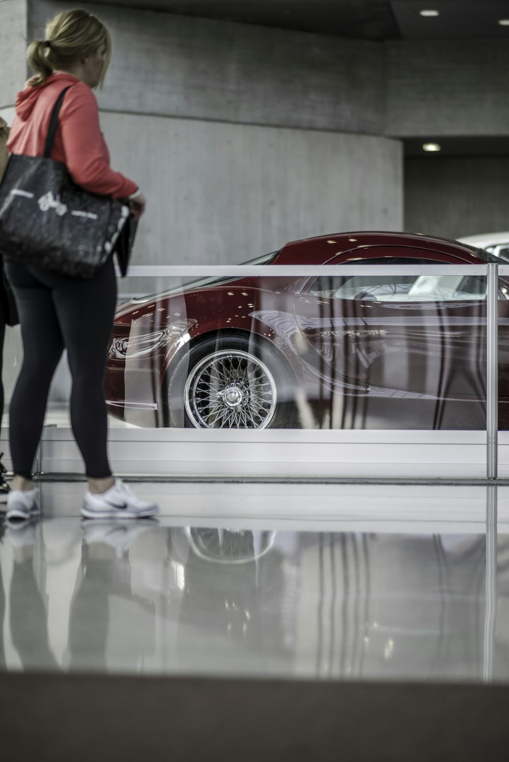 woman standing near coupe car during daytime