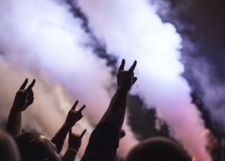 photo of persons doing rock hand sign