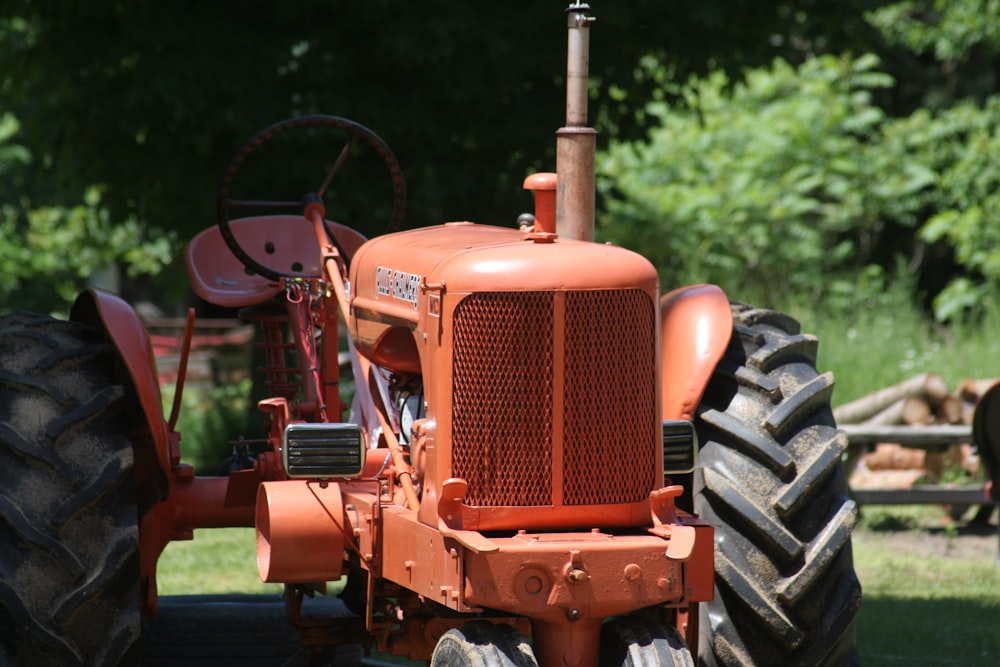 brown tractor on green grass field during daytime