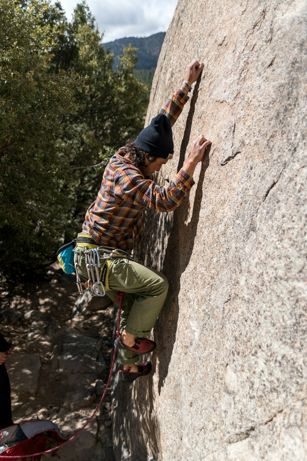 man climbing on rock during daytime