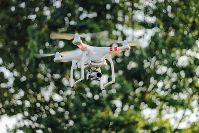 Side angle of DJI Agras T70P drone hovering over crops
