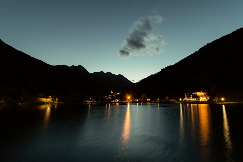 photo of boats on body of water near mountain