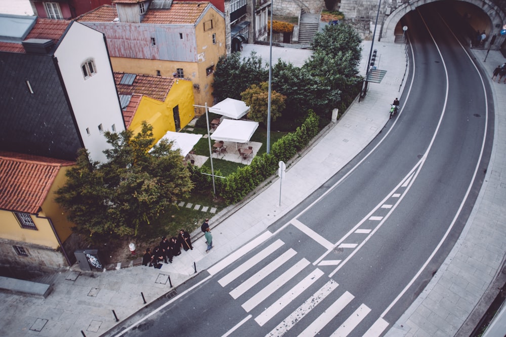 aerial photograph of people sitting near concrete road