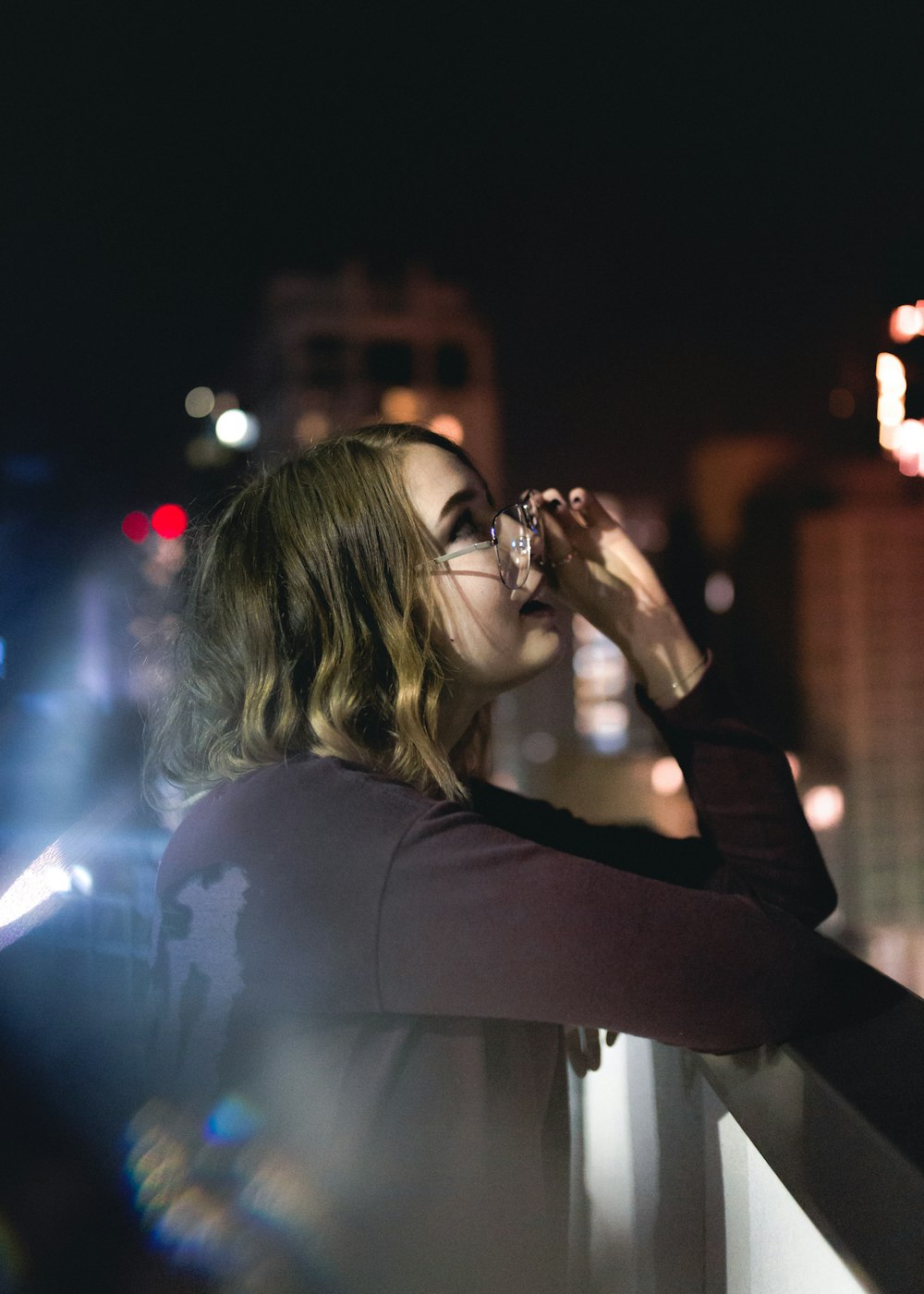 woman holding her eyeglasses