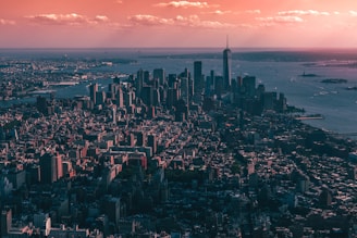 A high-resolution aerial view of Miami's bustling commercial district at sunset, showcasing skyscrapers and waterfront.