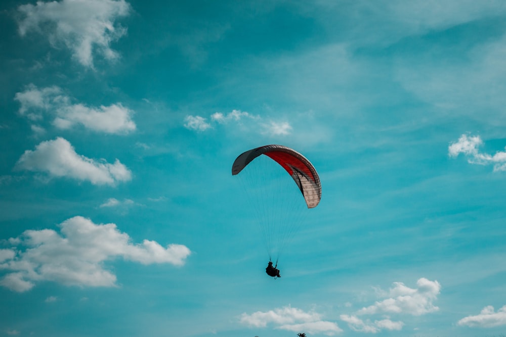 person riding parachute during daytime
