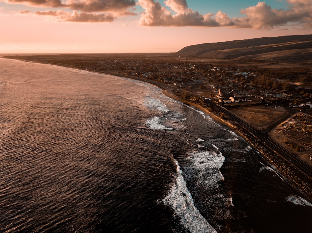 bird's eyeview photo of waves crashing sand