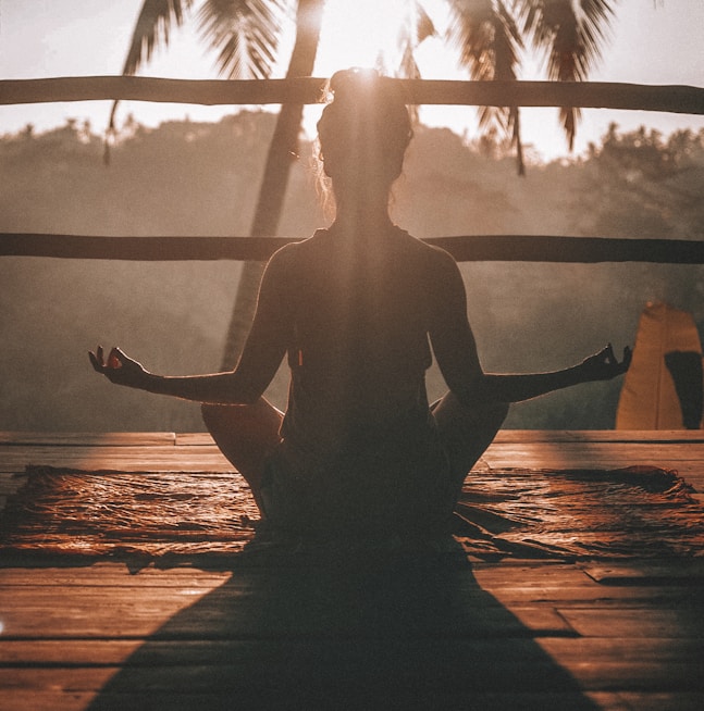 woman doing yoga meditation on brown parquet flooring