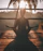 woman doing yoga meditation on brown parquet flooring