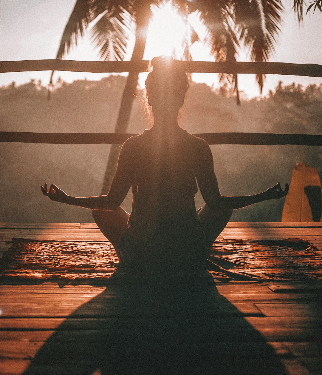  woman doing yoga meditation on brown parquet flooring weighing balance