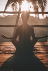 woman doing yoga meditation on brown parquet flooring