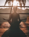 woman doing yoga meditation on brown parquet flooring