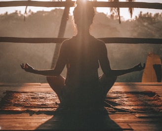 woman doing yoga meditation on brown parquet flooring